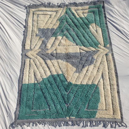 Authentic Beni Mrirt Moroccan rug 203×294 cm laid flat — bold architectural geometric design with teal emerald green concentric diamond and rectangular frames on cream ivory background with grey lavender triangular accents, hand-knotted in Morocco's Middle Atlas mountains with 100% natural wool
