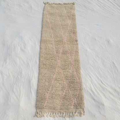 Authentic Beni Ourain Moroccan runner rug 84x284 cm laid flat - luminous ivory wool base with delicate sparse dusty pink diagonal lines crossing the field, the most minimal colour statement in our collection, handwoven in Morocco by Beni Ourain Berber women
