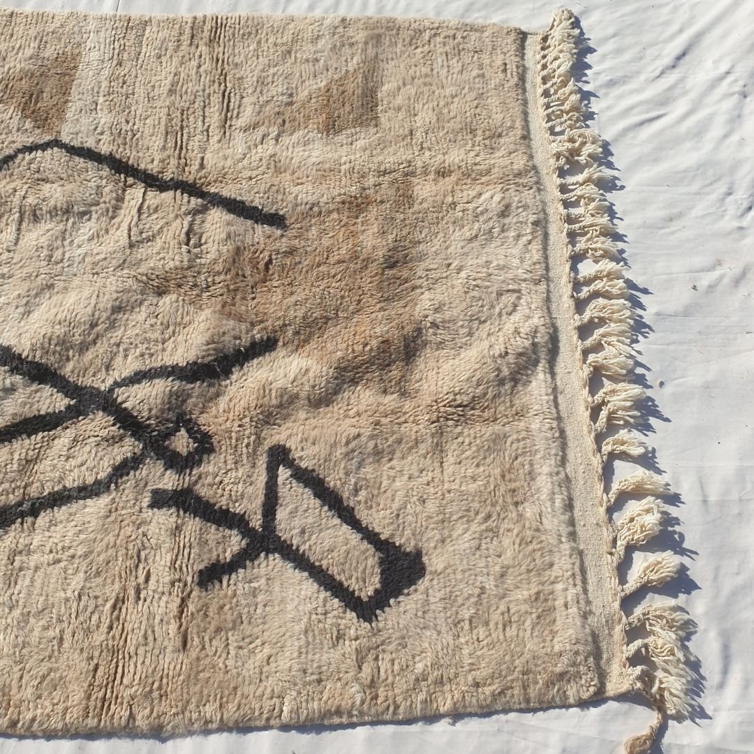 Striking black abstract diamond lines and X-shape crossing on ivory field of authentic Beni Ourain Moroccan wool rug