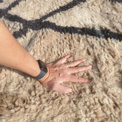 Ultra soft fluffy high-pile wool texture detail of ivory Beni Ourain plush shag rug