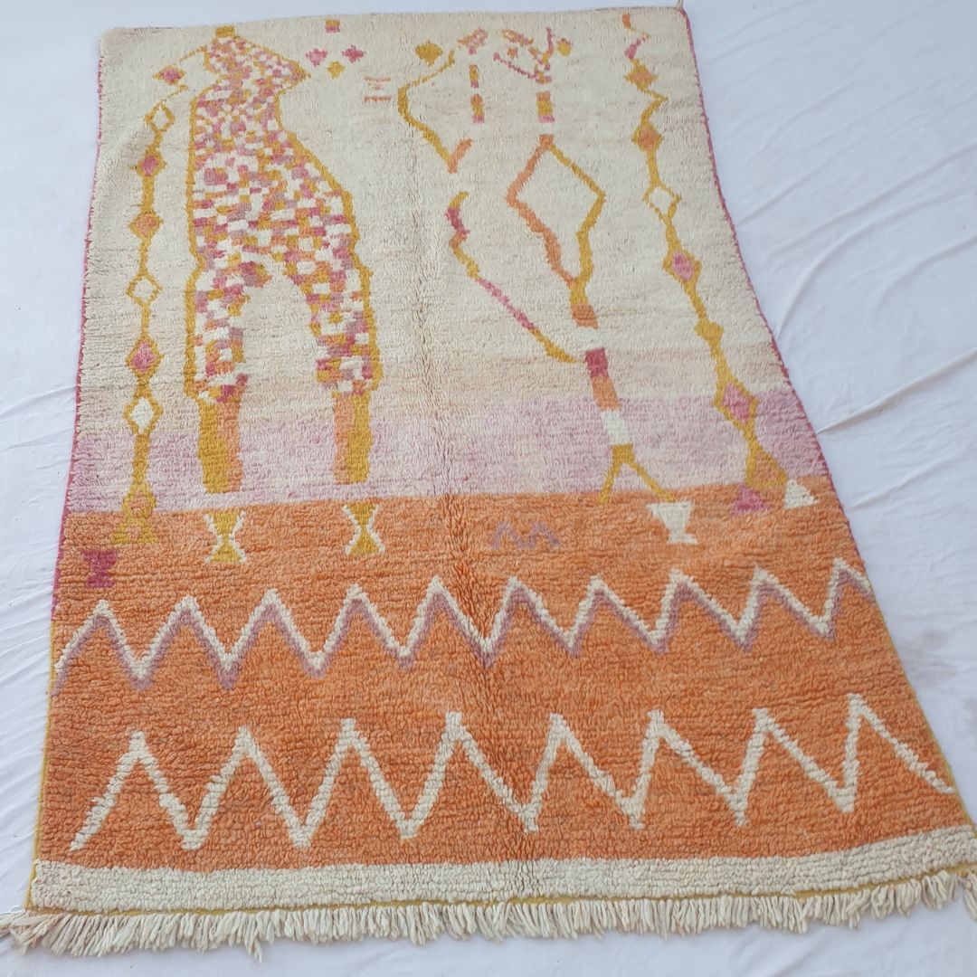 Detailed zigzag border and hand-knotted fringe in warm orange tones of 6x10 figurative Boujad Moroccan rug