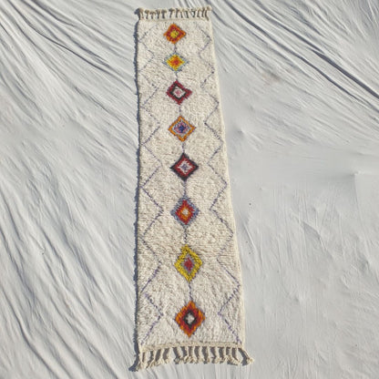 Authentic Beni Ourain Moroccan runner rug 69×290 cm laid flat — white cream natural wool base with a fine continuous diamond lattice background and a central column of solid-filled diamonds in warm earthy tones: orange, rust, yellow, wine red and mauve, handwoven in Morocco by Beni Ourain Berber women