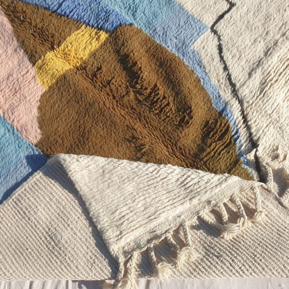 Hand-knotted fringe and outlined border in creamy ivory framing the vibrant geometric design of 6x9 Beni Ourain Moroccan rug