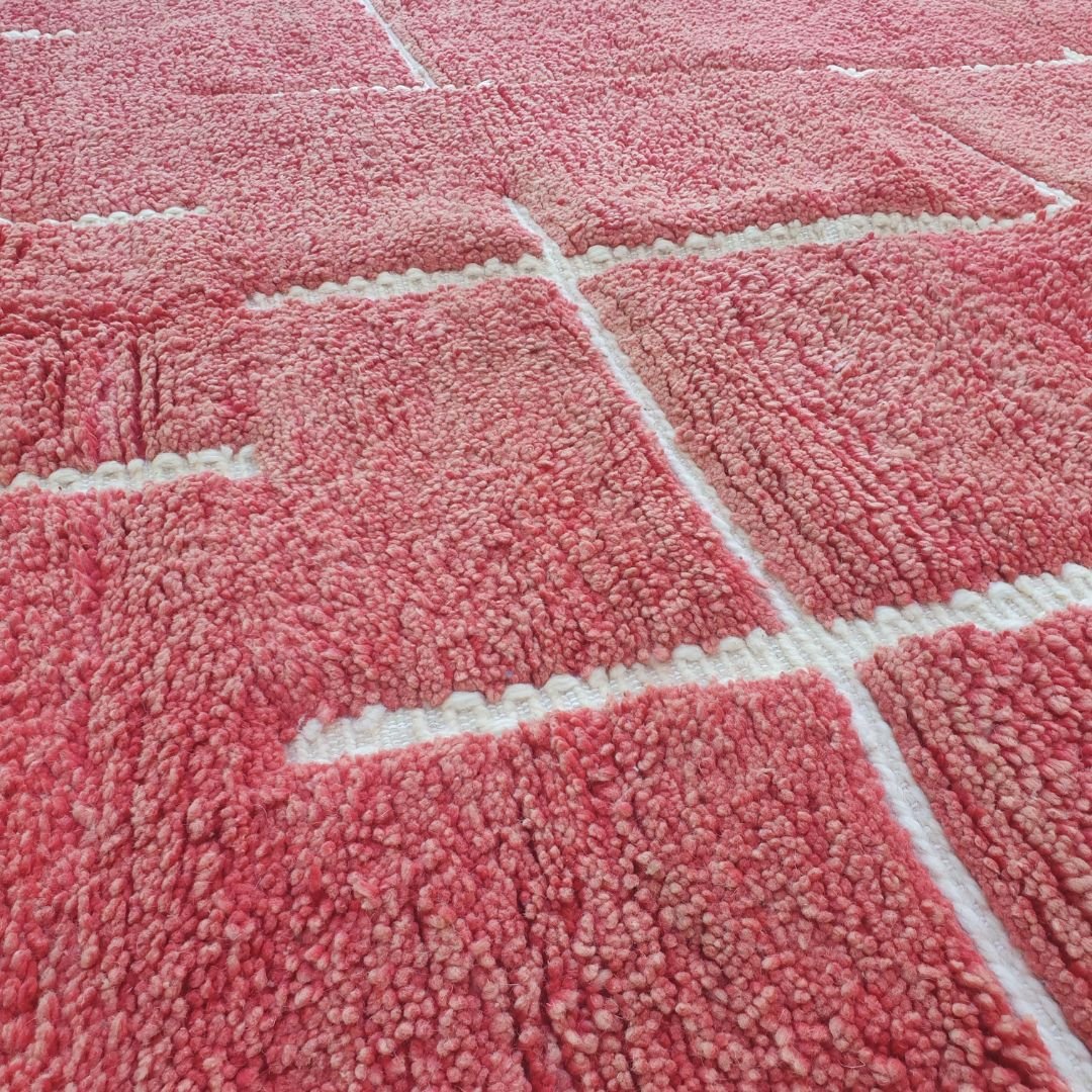 Plush fluffy pile texture on bold red geometric Beni Ourain Moroccan shag rug, soft wool details