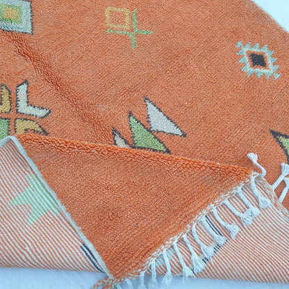 Hand-knotted fringe and detailed border in warm orange tones of 6x9 vibrant Boujad Moroccan rug