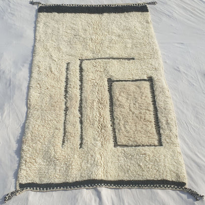Authentic Beni Ourain Moroccan rug 154x264 cm laid flat - white ivory natural wool base with a bold asymmetric black line art composition: two vertical lines left, rectangle outline lower right, solid black border stripes at both ends, handwoven in Morocco by Beni Ourain Berber women