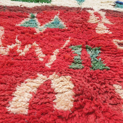Detailed handwoven Berber tribal motifs including protective diamonds, arrows, crosses, abstract symbols and colorful geometric blocks in red, orange, pink, green and blue on authentic Boujad Moroccan rug