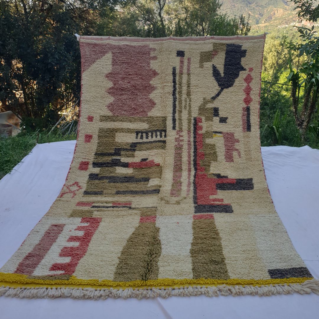 large ivory and olive Boujad Moroccan rug in nature, bold architectural column motifs in olive green and charcoal with vivid yellow bottom border.