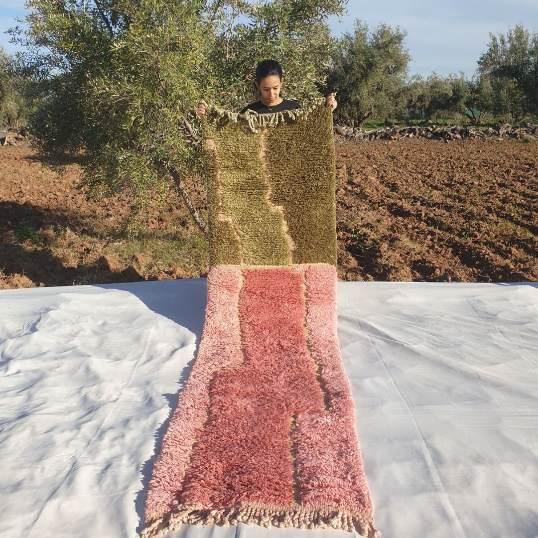 Luxury 2x10 Beni Mrirt Moroccan runner rug in olive green and pastel pink abstract wavy shag design held outdoors amid olive trees