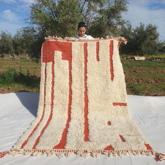 Super soft 5x8 Beni Ourain Moroccan rug in ivory with burnt orange vertical stripes ultra thick fluffy pile held outdoors