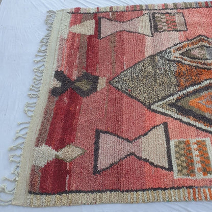 Soft natural wool pile and rich color variations of vintage-style Boujad Berber rug in coral red tones