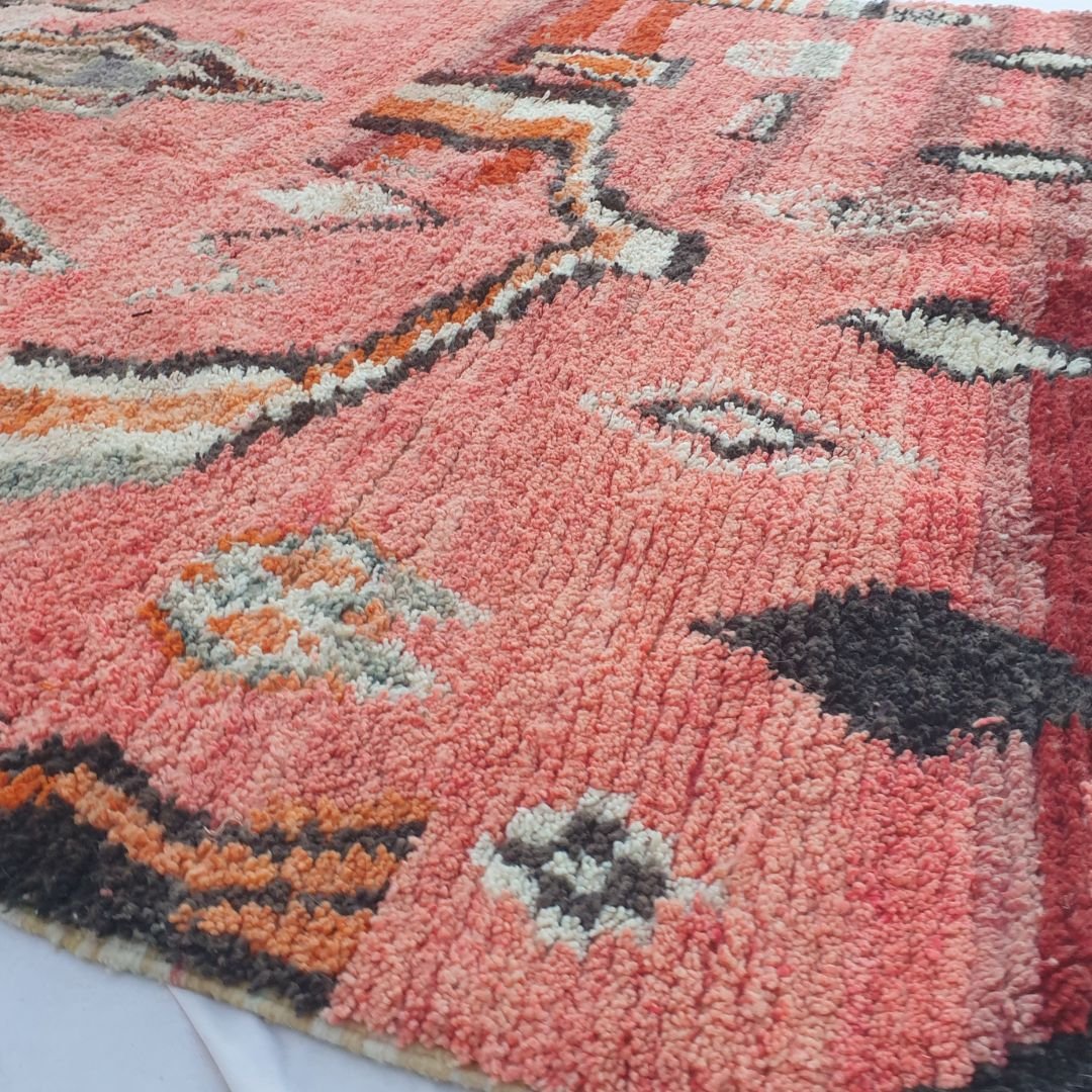 Detailed handwoven tribal motifs and diamonds on authentic coral red Boujad Moroccan wool rug