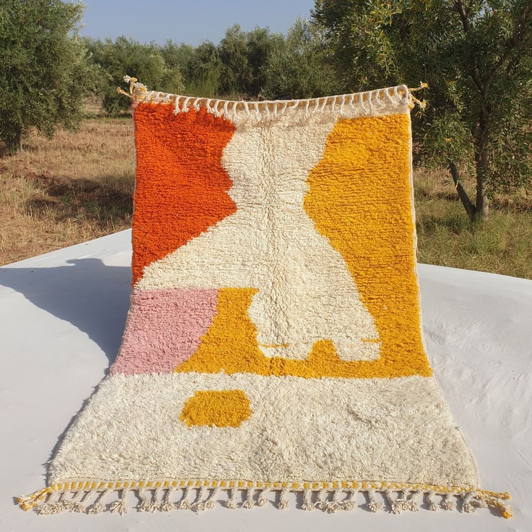 Handmade orange and yellow Moroccan rug 5x8, Beni Ourain wool shag rug with abstract patterns in outdoor setting