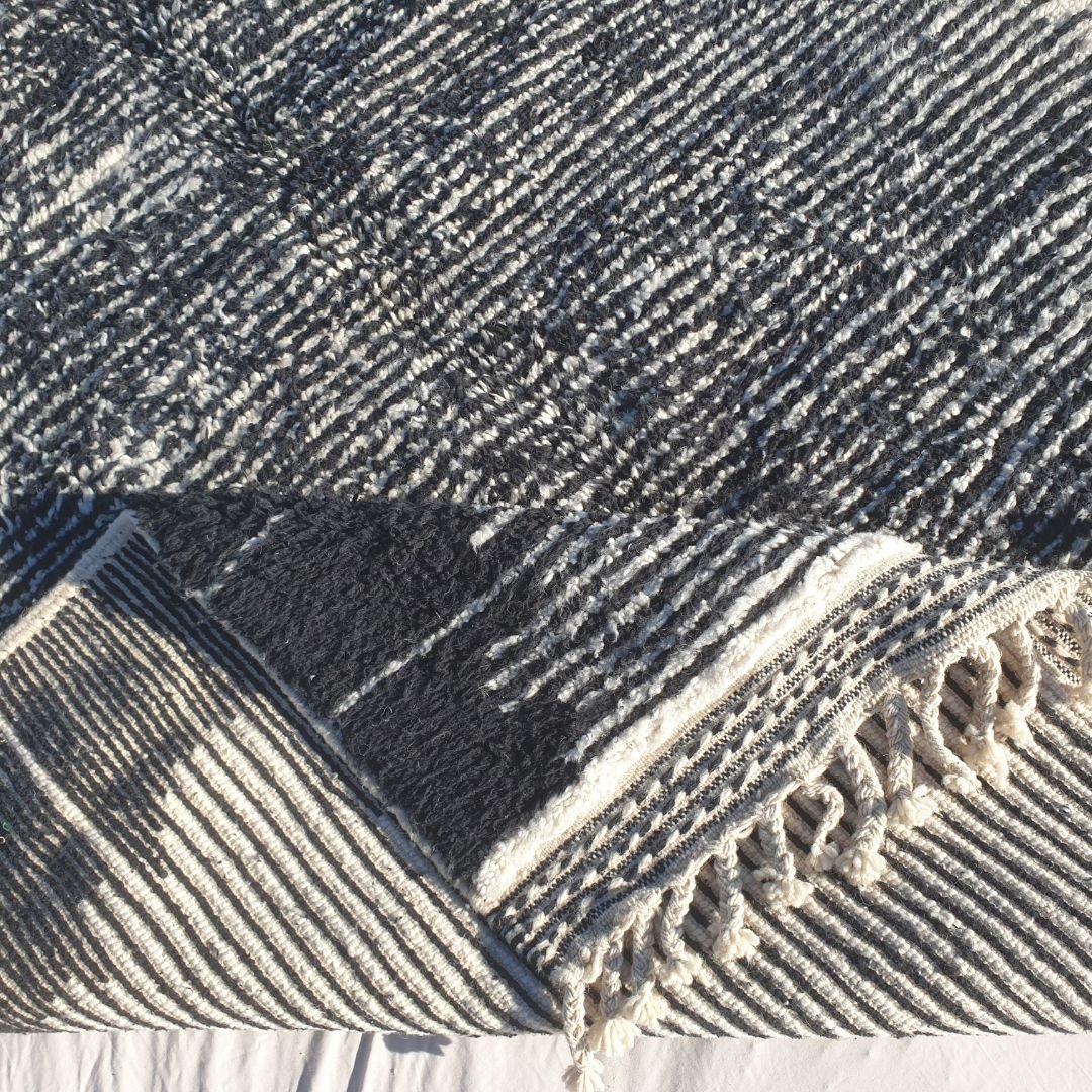 Hand-knotted fringe and border detail in creamy ivory with black accents on 6x10 classic Beni Ourain Moroccan rug