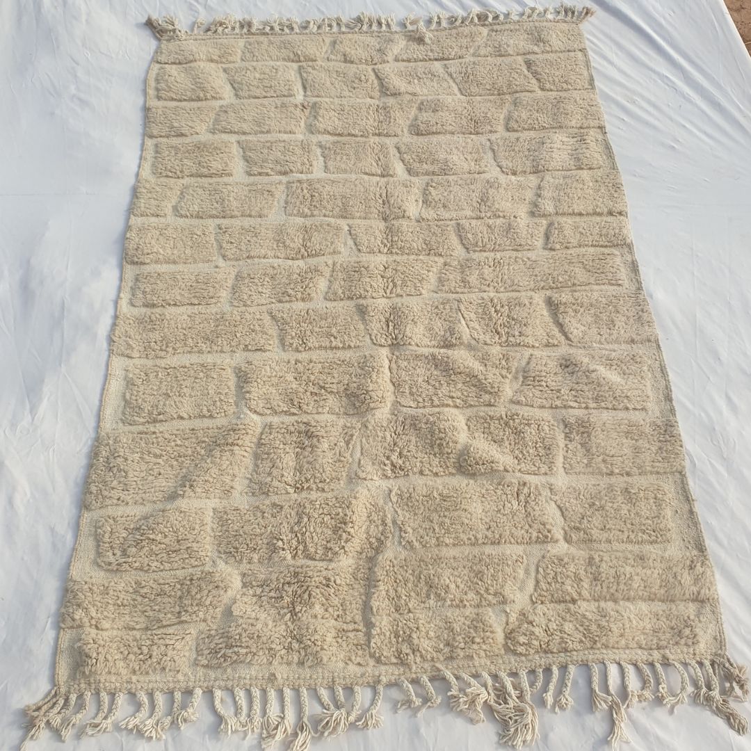 Authentic Beni Ourain Moroccan rug 201x314 cm laid flat - warm ivory undyed natural wool with a full-field cobblestone and brick carved pile relief pattern, an architectural and sculptural Moroccan rug handwoven in Morocco by Beni Ourain Berber women