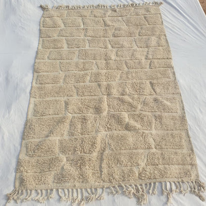 Authentic Beni Ourain Moroccan rug 201x314 cm laid flat - warm ivory undyed natural wool with a full-field cobblestone and brick carved pile relief pattern, an architectural and sculptural Moroccan rug handwoven in Morocco by Beni Ourain Berber women